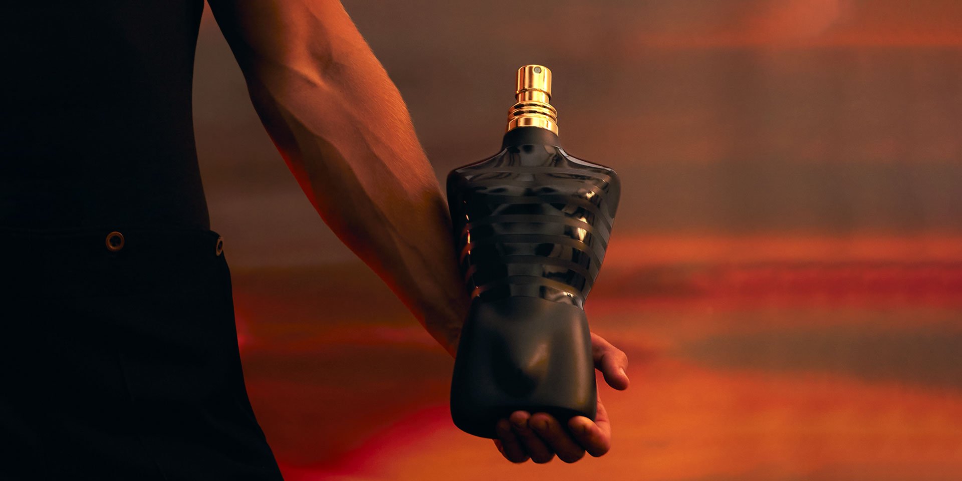 Le Male le Parfum bottle with sunset background