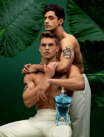 Male models with Le Beau EDT bottle on dark green background