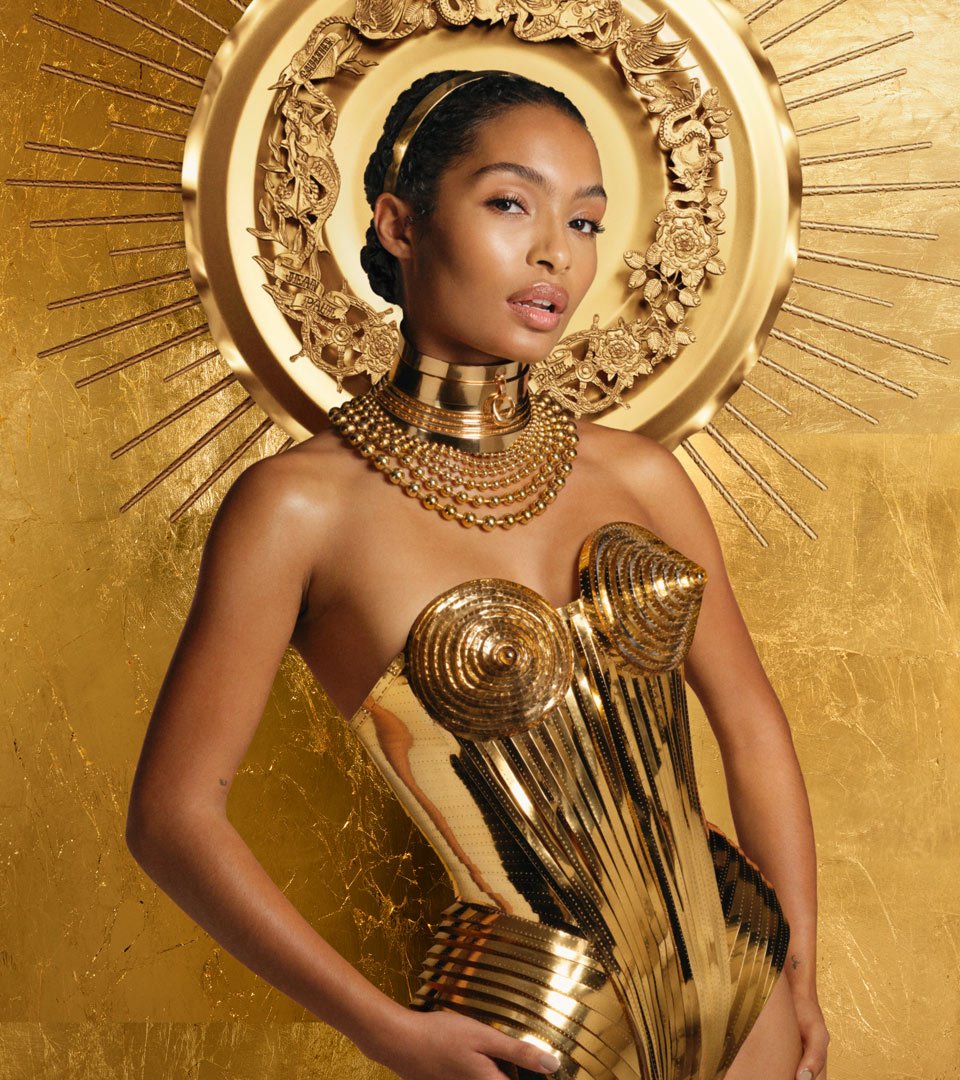 pré home Gaultier Divine with Yara Shahidi with a gold background